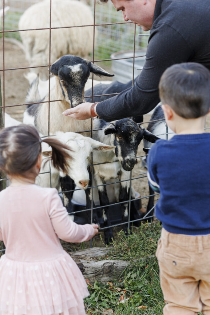 dad with son and daughter on goat farm in Montana