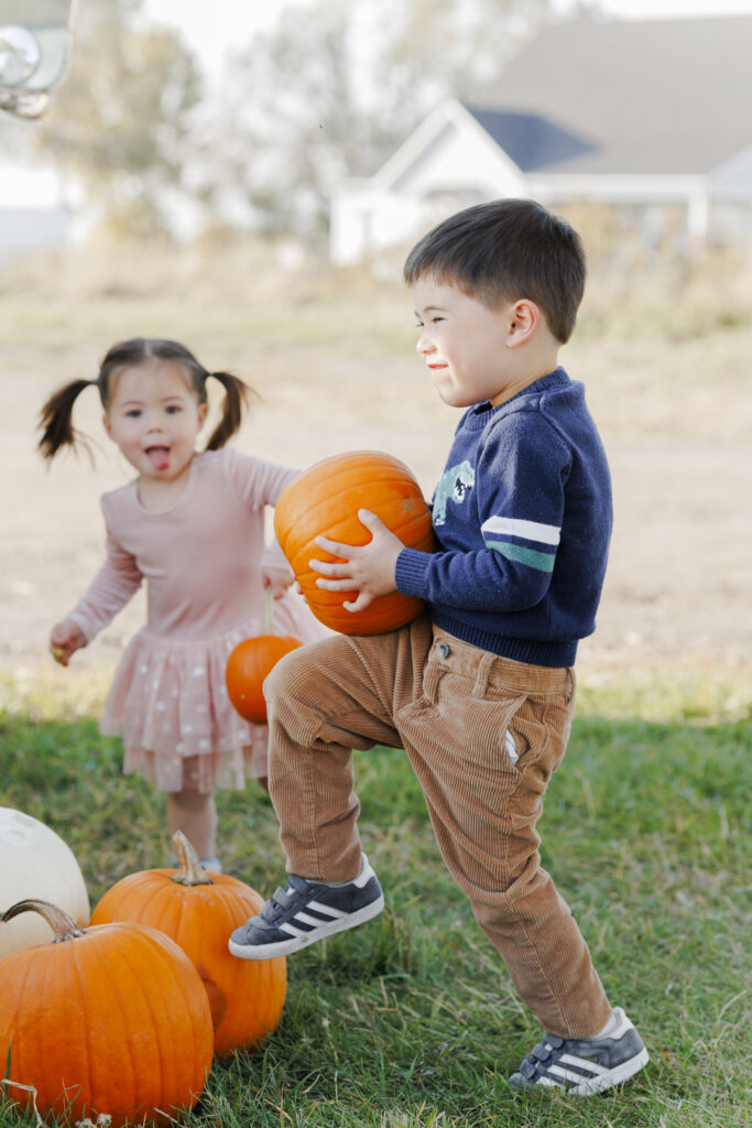 brother and sister pick pumpkins at a farm in Montana