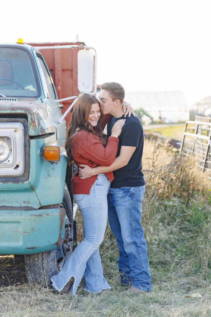 couple with a turquoise truck on a farm in Montana