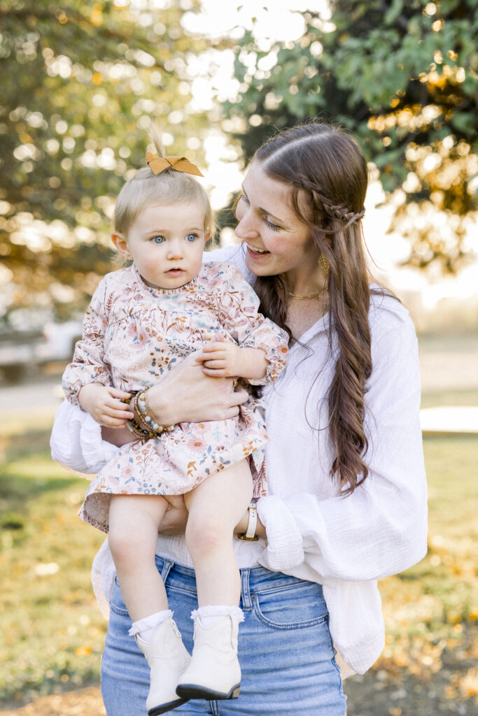 mom holds toddler girl at a goat farm in Montana