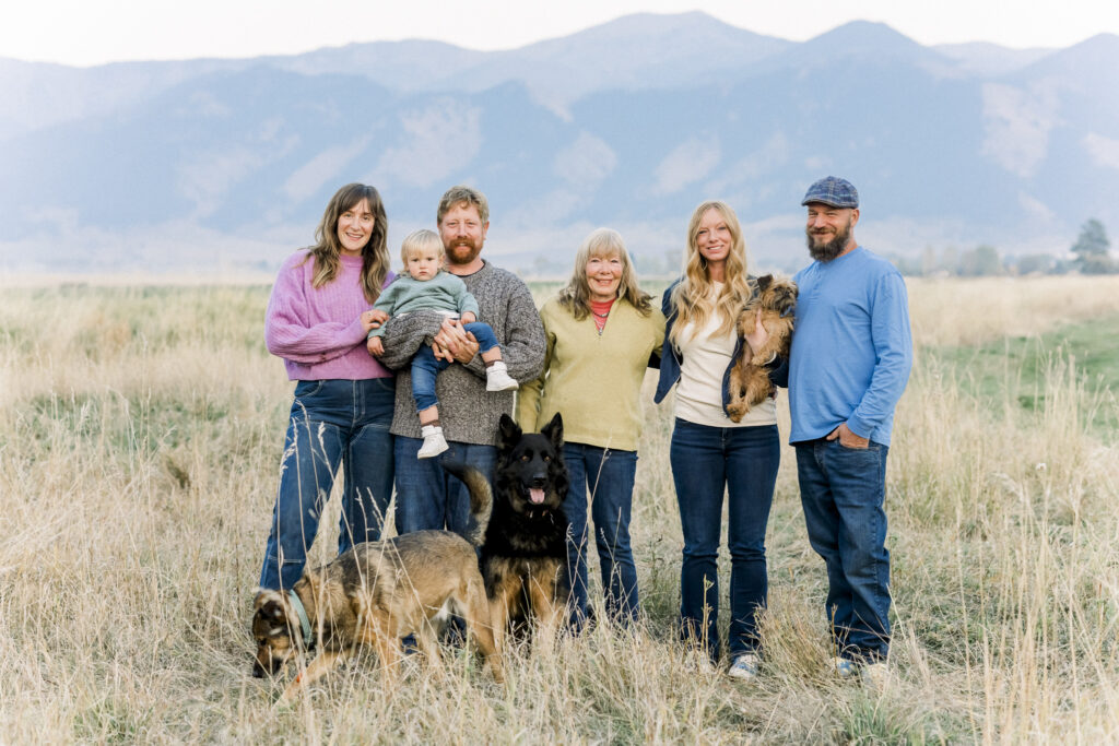 group family photo on dairy farm in front of Bridger mountains in Montana