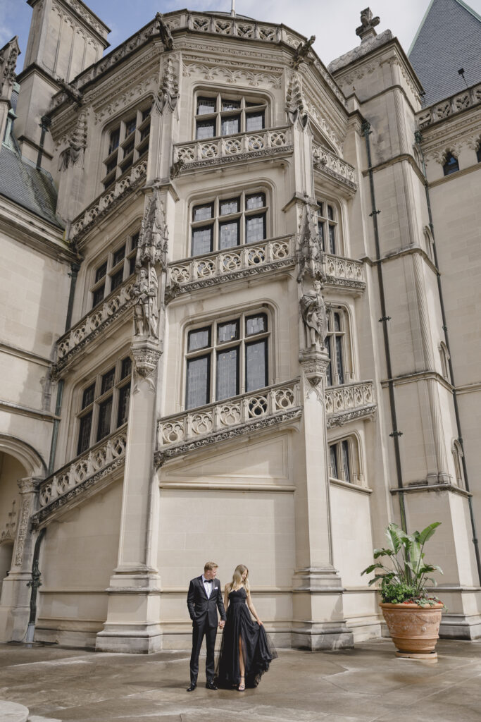 Engaged couple in black dress and black tux at the Biltmore Estate