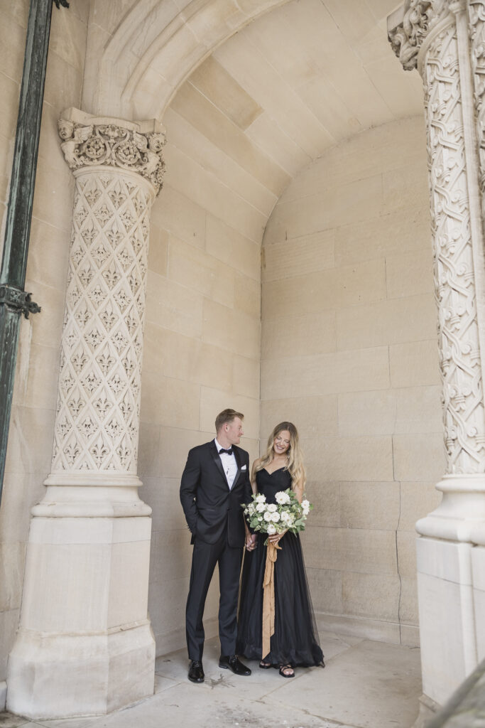 Black tie Engagement photo session at the Biltmore with black tulle dress. Rachel Deneroy Designs white floral bouquet using blueberries and mint at the Biltmore Estate.