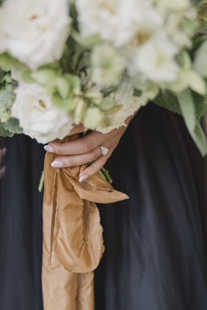 Black tie Engagement photo session at the Biltmore with black tulle dress. Rachel Deneroy Designs white floral bouquet using blueberries and mint at the Biltmore Estate.