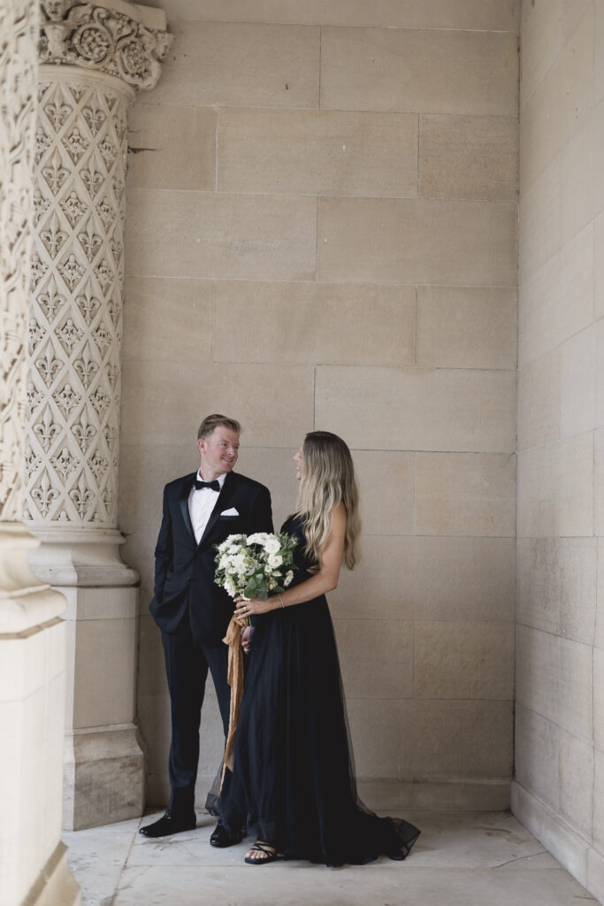 Black tie Engagement photo session at the Biltmore with black tulle dress. Rachel Deneroy Designs white floral bouquet using blueberries and mint at the Biltmore Estate.