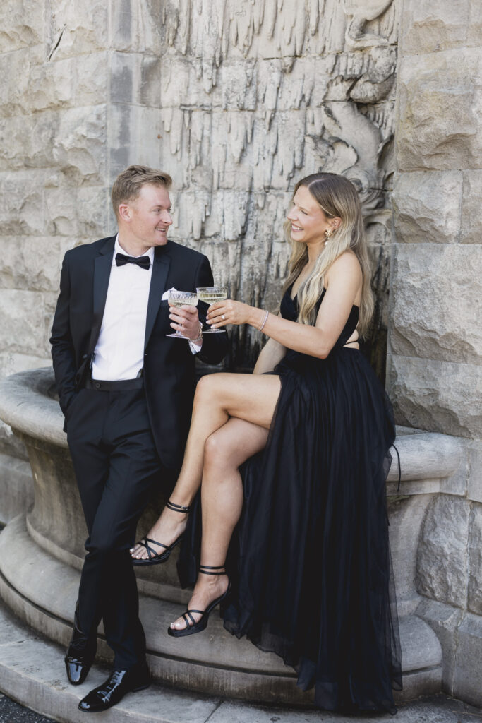 Biltmore engagement session with black tux and bowtie and black tulle dress with champagne pop